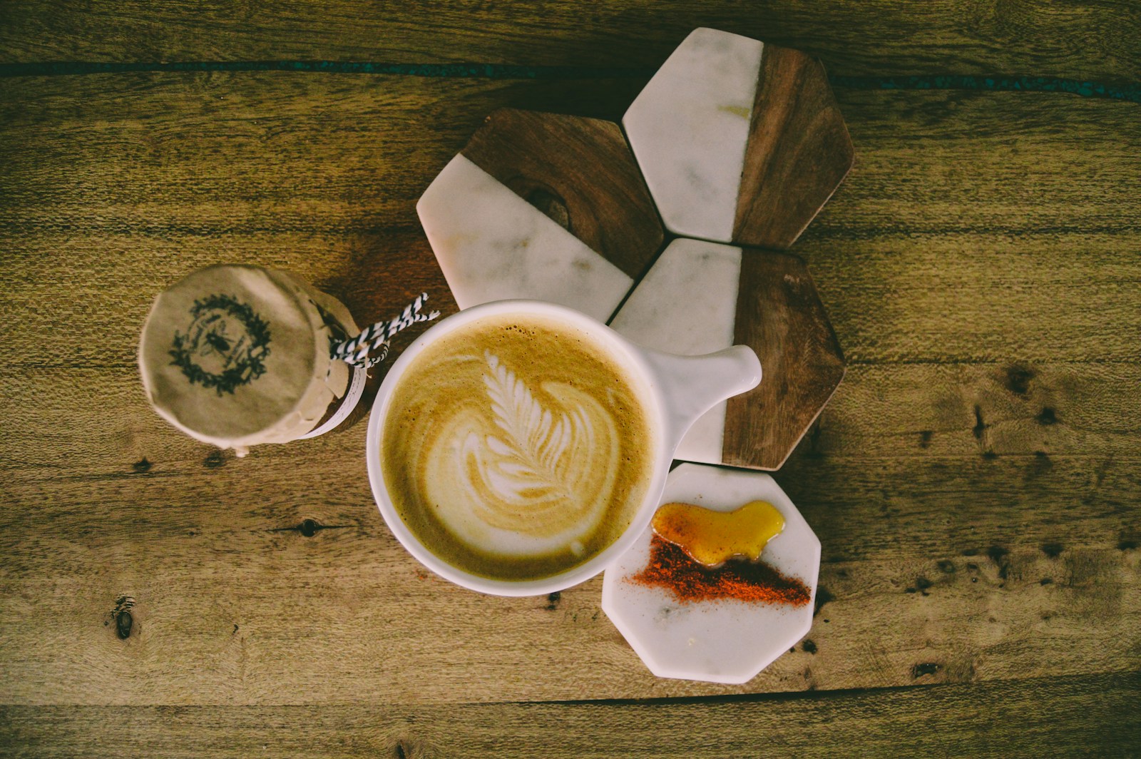 a cup of coffee on a wooden table